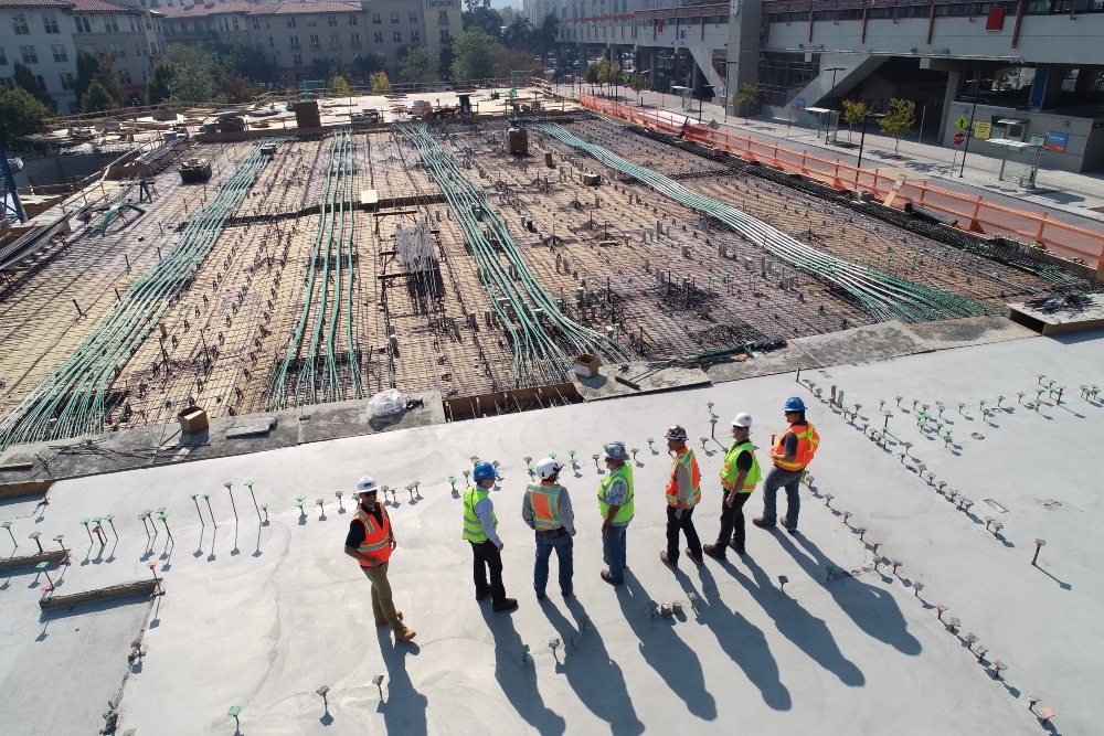 men with hard hats working at height